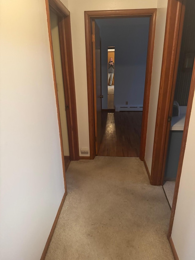 1313 Corbett Rd, Detroit Lakes, MN 56501 - hallway featuring baseboard heating, carpet, and baseboards