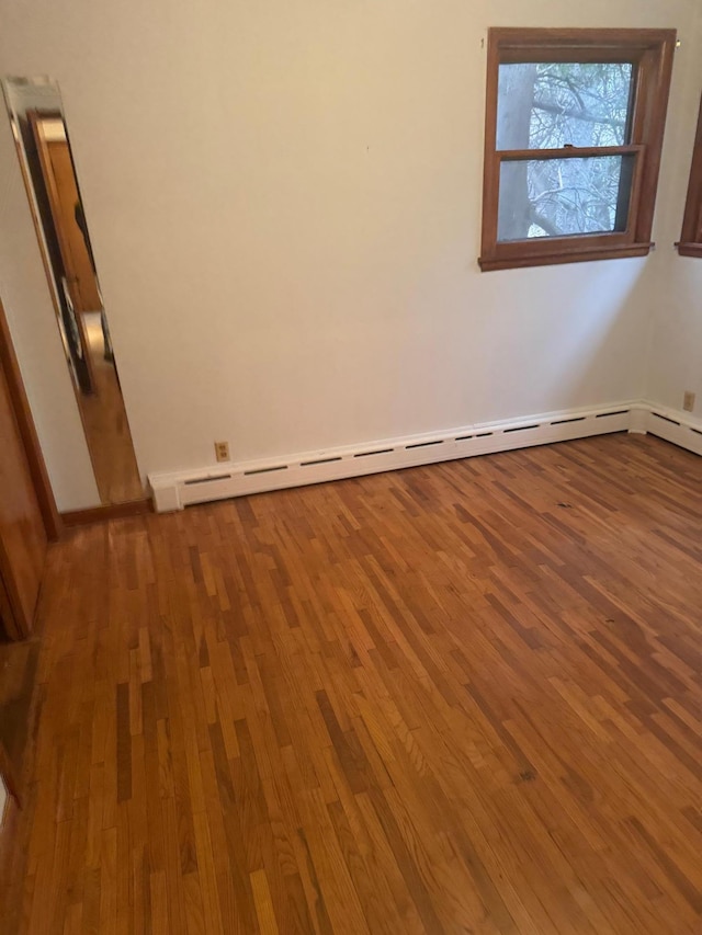 1313 Corbett Rd, Detroit Lakes, MN 56501 - spare room with a baseboard radiator, wood finished floors, and baseboards