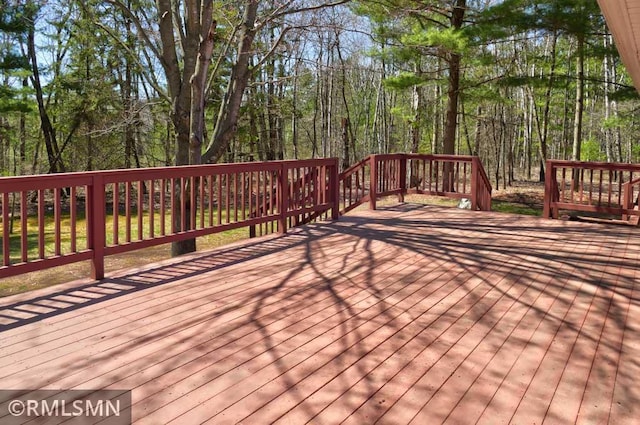 wooden deck with a forest view