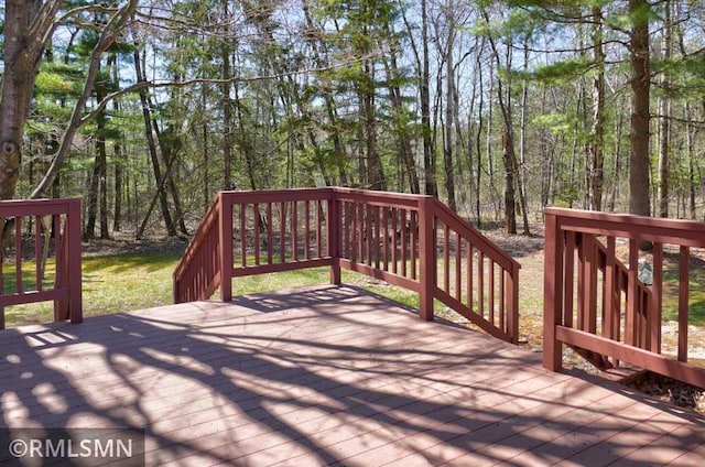 wooden deck with a wooded view
