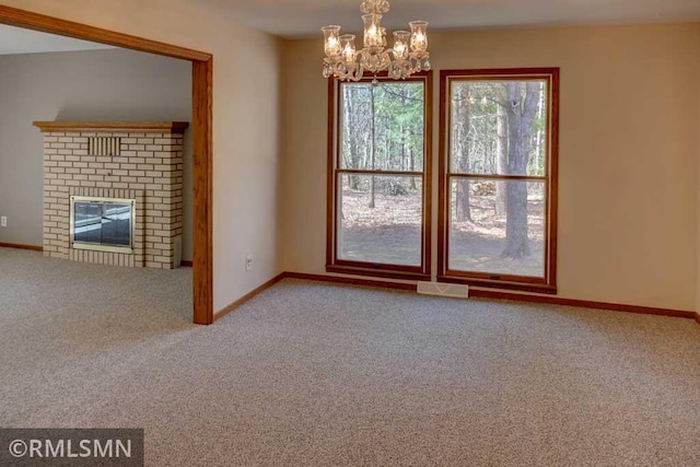 interior space featuring an inviting chandelier, carpet, and baseboards