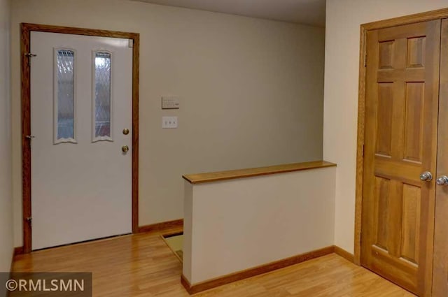 entrance foyer featuring baseboards and light wood-type flooring