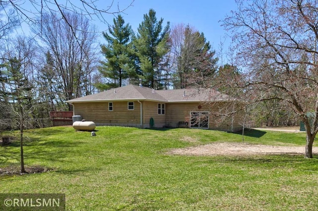 rear view of house with a yard