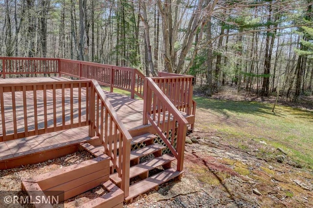 wooden terrace featuring a lawn