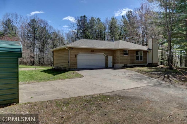 view of property exterior featuring a yard, an attached garage, and concrete driveway