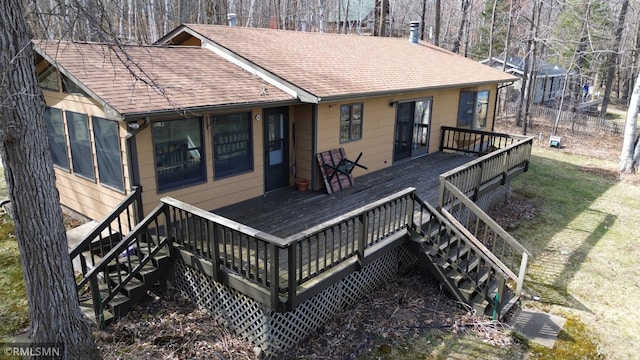 wooden terrace with a lawn and stairway