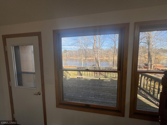 doorway to outside with a water view