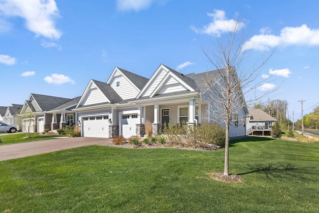 craftsman inspired home featuring an attached garage, a front yard, and stone siding
