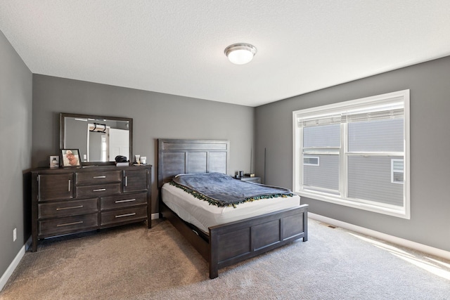 carpeted bedroom featuring baseboards