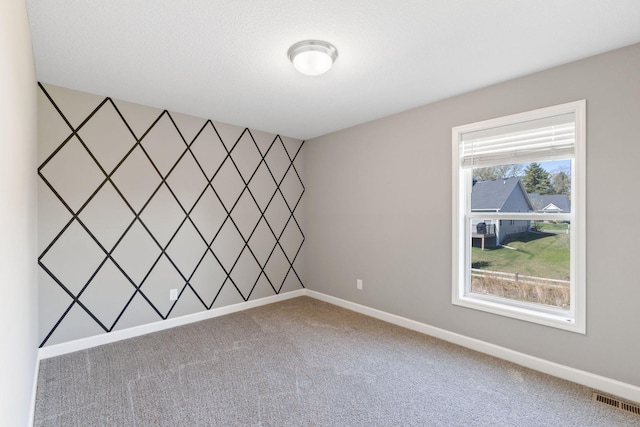 spare room with carpet and baseboards