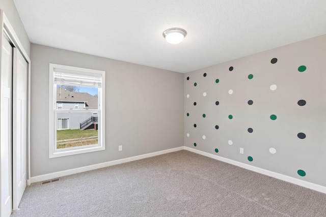 spare room with light carpet and baseboards