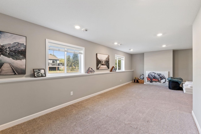 below grade area featuring carpet floors, baseboards, and recessed lighting