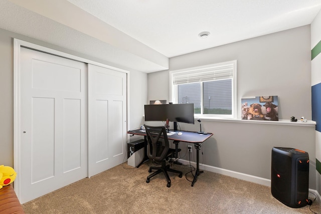 carpeted home office with baseboards