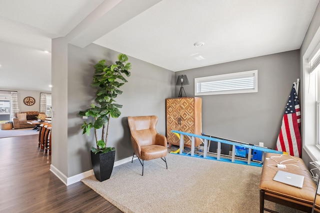 living area with wood finished floors and baseboards