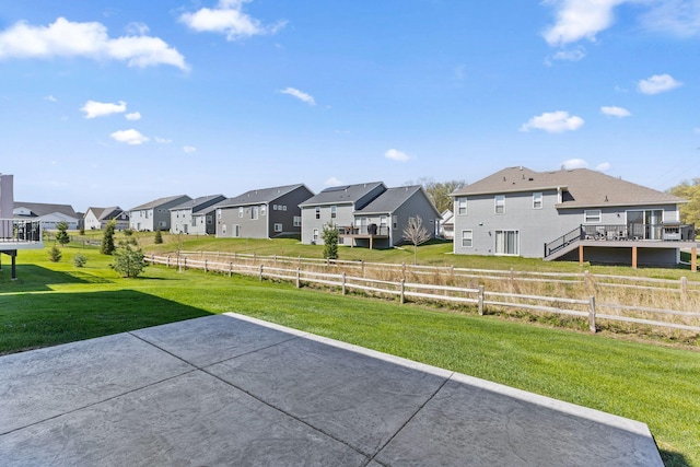 view of yard featuring a residential view and a patio
