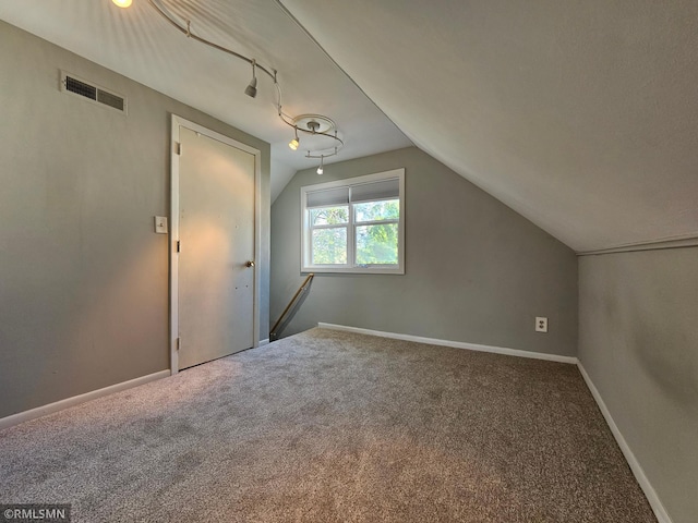 bonus room with carpet floors, baseboards, visible vents, and lofted ceiling