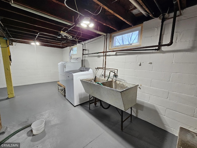 basement with independent washer and dryer, a sink, and a healthy amount of sunlight