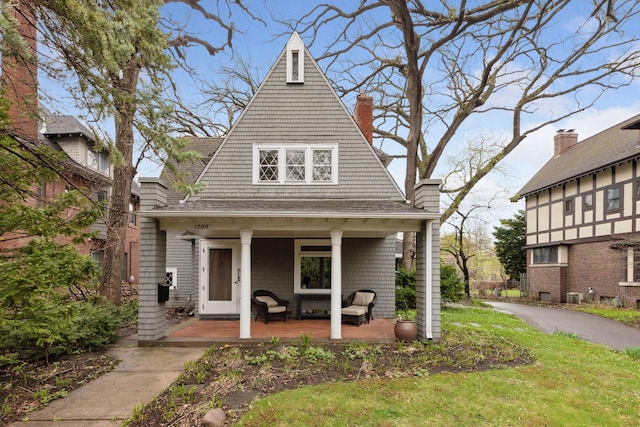 view of front of house with a porch and roof with shingles