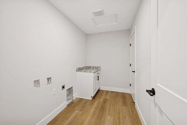 laundry room with cabinet space, hookup for a washing machine, electric dryer hookup, baseboards, and light wood-type flooring