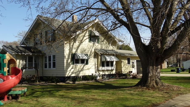 view of property exterior featuring a lawn and a chimney