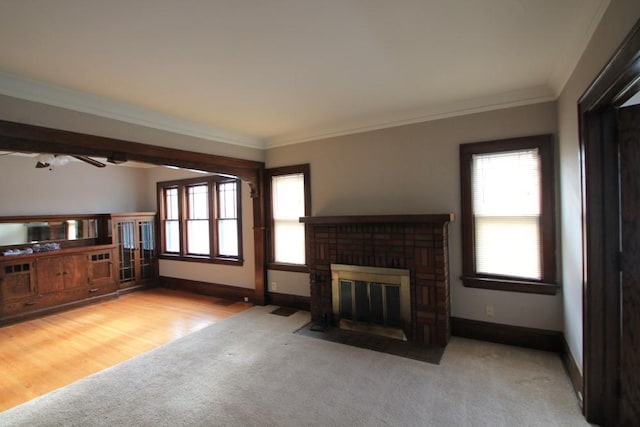 unfurnished living room with carpet floors, baseboards, a brick fireplace, and a healthy amount of sunlight