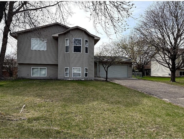 9007 Hampshire Ave N, Brooklyn Park, MN 55445 - split level home featuring an attached garage, driveway, and a front yard
