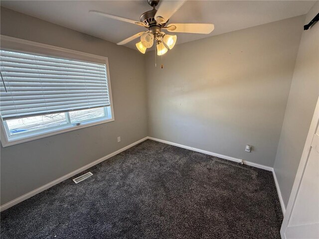 9007 Hampshire Ave N, Brooklyn Park, MN 55445 - unfurnished room featuring baseboards, ceiling fan, dark colored carpet, and visible vents