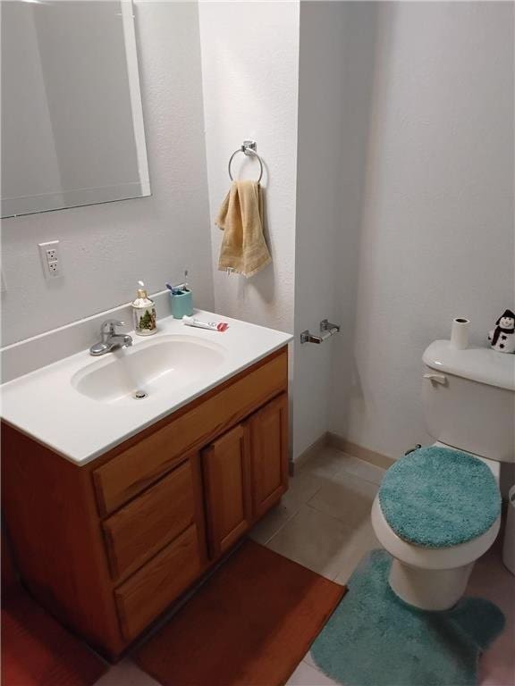 9007 Hampshire Ave N, Brooklyn Park, MN 55445 - half bathroom with vanity, tile patterned flooring, and toilet