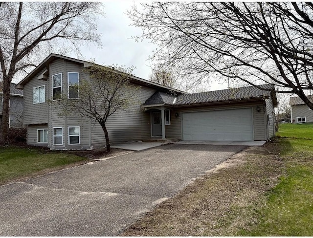 9007 Hampshire Ave N, Brooklyn Park, MN 55445 - tri-level home featuring an attached garage and driveway