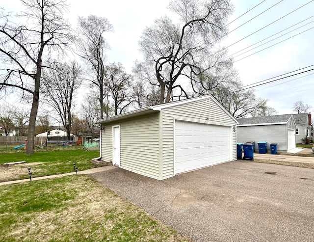 detached garage featuring fence