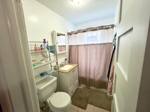 full bathroom with vanity, toilet, a textured ceiling, tile patterned floors, and shower / tub combo