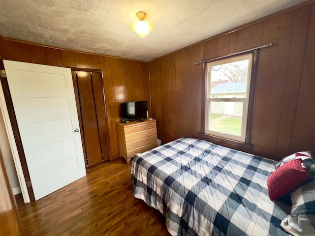 bedroom with dark wood-style flooring