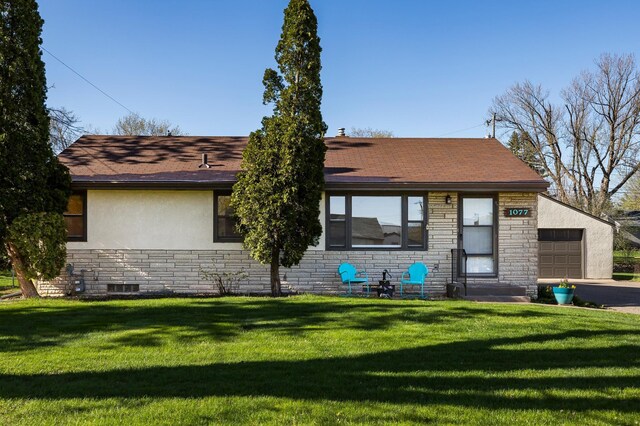 view of front of property with a garage, stucco siding, a front lawn, and stone siding