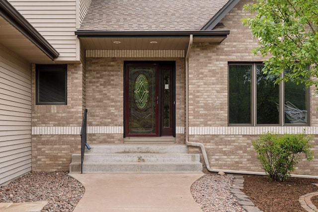 16439 Tippecanoe St NE, Ham Lake, MN 55304 - view of exterior entry featuring roof with shingles and brick siding