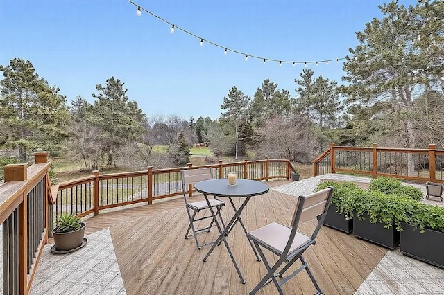 16439 Tippecanoe St NE, Ham Lake, MN 55304 - wooden terrace featuring view of wooded area and outdoor dining space