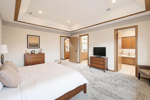 16439 Tippecanoe St NE, Ham Lake, MN 55304 - bedroom with ensuite bathroom, a sink, light colored carpet, a tray ceiling, and recessed lighting