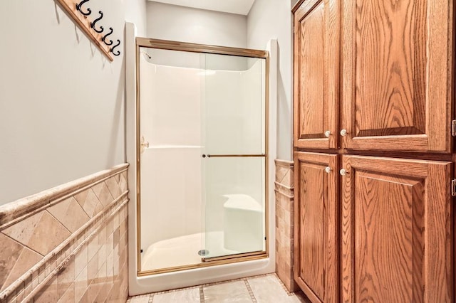 16439 Tippecanoe St NE, Ham Lake, MN 55304 - bathroom with a shower stall, tile walls, and wainscoting
