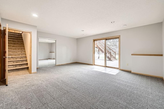 16439 Tippecanoe St NE, Ham Lake, MN 55304 - unfurnished bedroom featuring access to exterior, carpet, baseboards, recessed lighting, and a textured ceiling