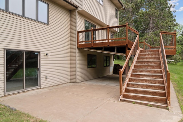 16439 Tippecanoe St NE, Ham Lake, MN 55304 - view of patio / terrace featuring stairs, a wooden deck, concrete driveway, and a carport
