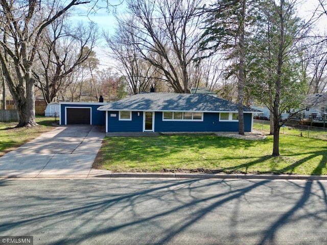 ranch-style house featuring fence, a garage, a front yard, an outbuilding, and driveway
