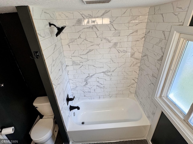 bathroom with visible vents, a textured ceiling, a healthy amount of sunlight, and toilet