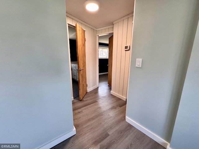 hallway with baseboards and wood finished floors