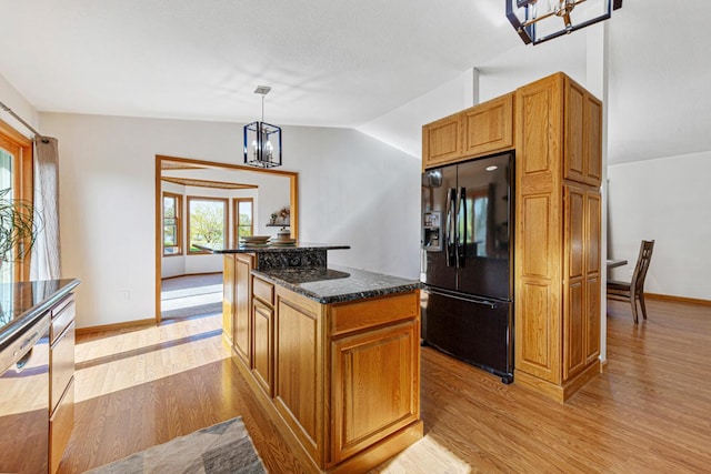 8370 Hamel Way, Morristown, MN 55052 - kitchen with black fridge, light wood-style floors, a chandelier, dark stone countertops, and a kitchen island