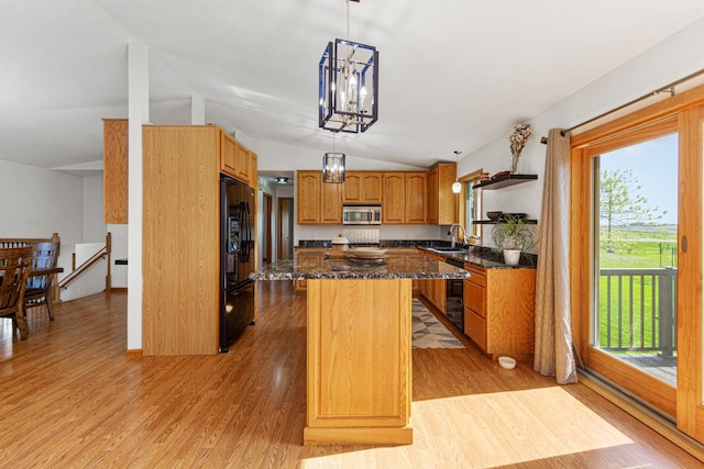8370 Hamel Way, Morristown, MN 55052 - kitchen featuring stainless steel microwave, freestanding refrigerator, a sink, lofted ceiling, and a center island