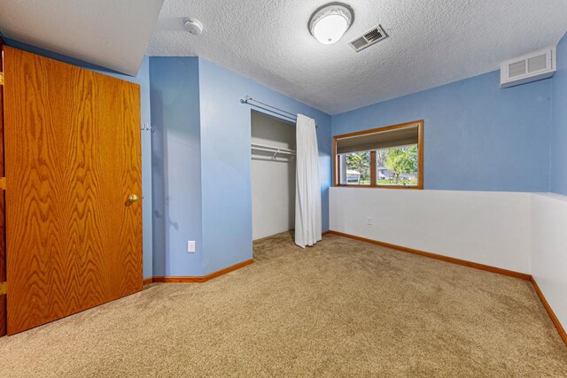 8370 Hamel Way, Morristown, MN 55052 - unfurnished bedroom with carpet flooring, a closet, a textured ceiling, and baseboards