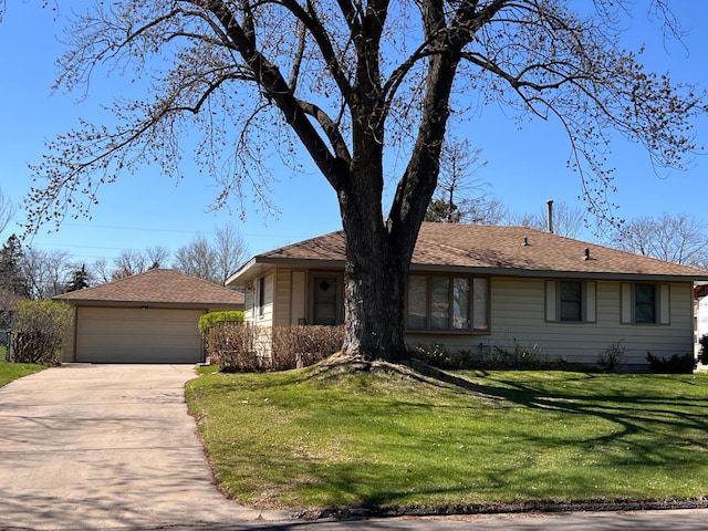 single story home with a garage, an outdoor structure, and a front lawn