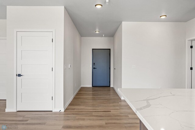 interior space with baseboards and light wood finished floors