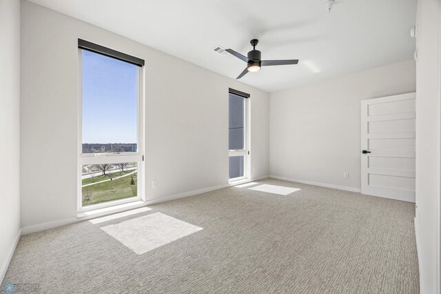 unfurnished bedroom featuring baseboards, a ceiling fan, carpet flooring, and visible vents