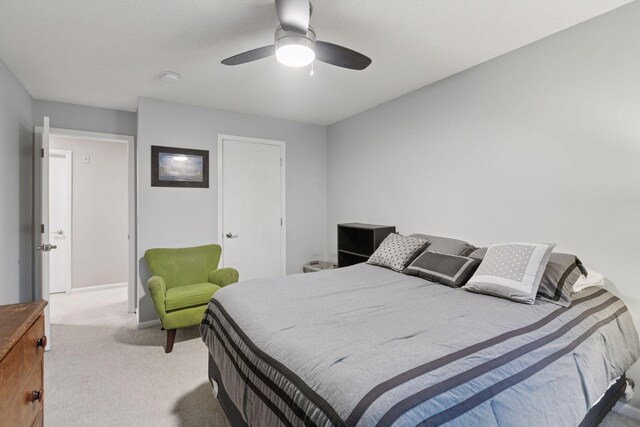 carpeted bedroom with baseboards and ceiling fan