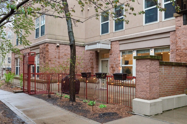 exterior space featuring fence and stucco siding